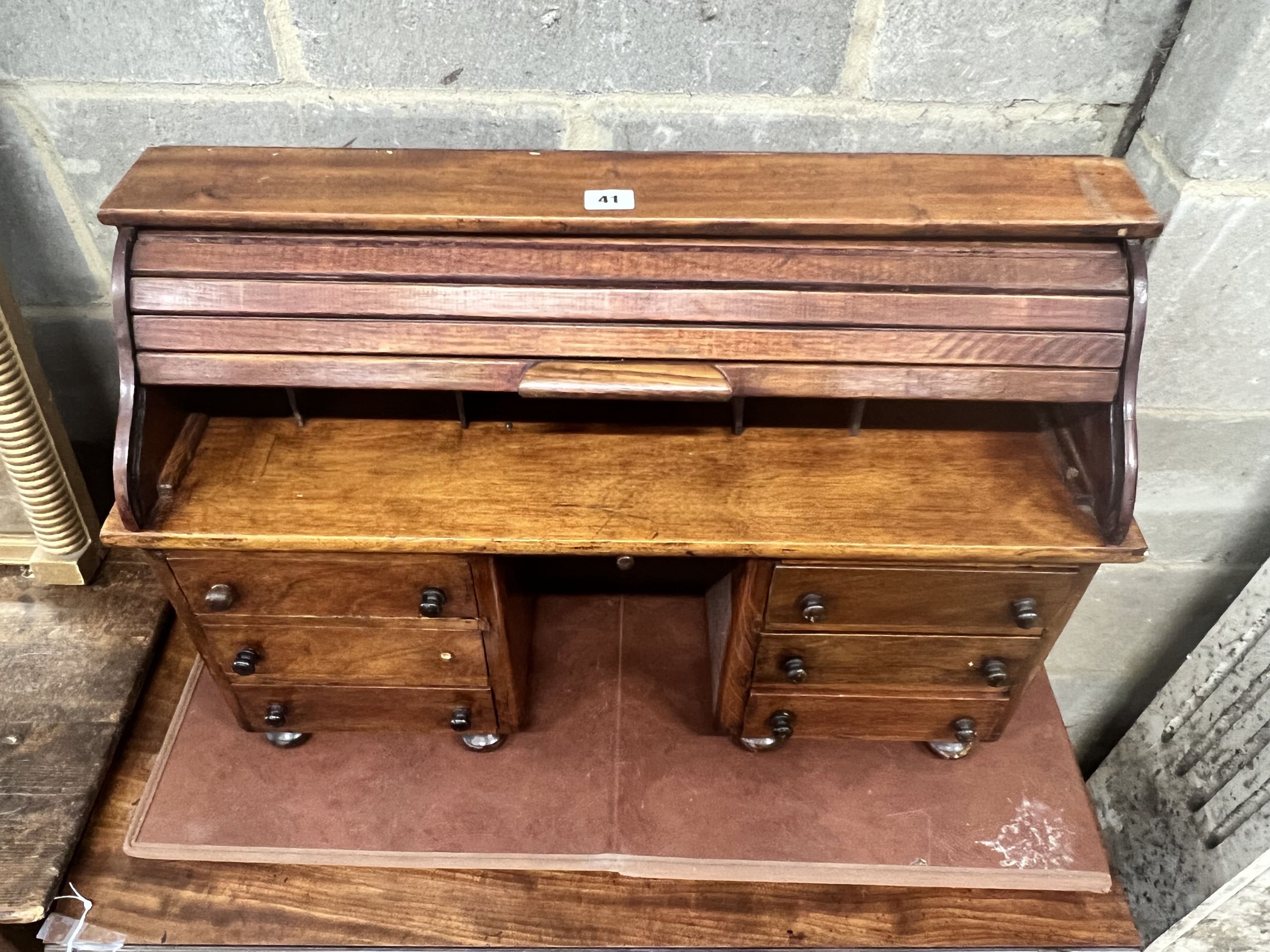 A miniature mahogany and hardwood kneehole tambour desk, width 69cm, depth 22cm, height 45cm.